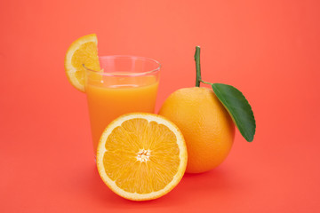 Orange juice and oranges with leaves