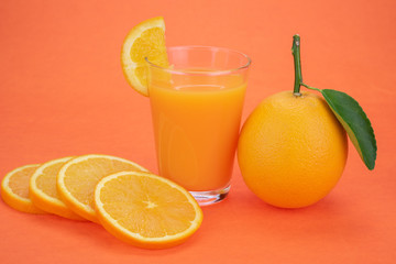 Orange juice and oranges with leaves