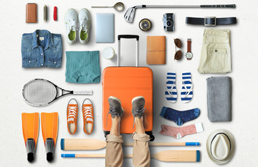 Travel concept with a large suitcase and other accessories