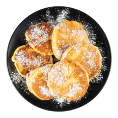 Fried cheesecakes in a black plate on a white isolated background.