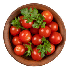 Tomatoes with parsley in a ceramic bowl on a white isolated background. 