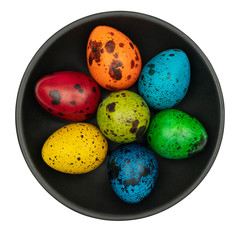 Colorful easter eggs on black plate isolated on white background.