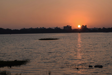 Fototapeta premium beautiful hot and red sunrise in the city of India