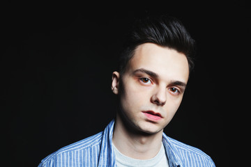 Young man face portrait in low key.