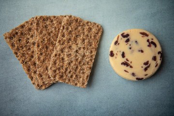 Cheese and crackers on blue background 