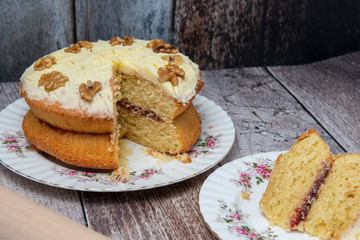 Walnut sponge cake on wooden background 