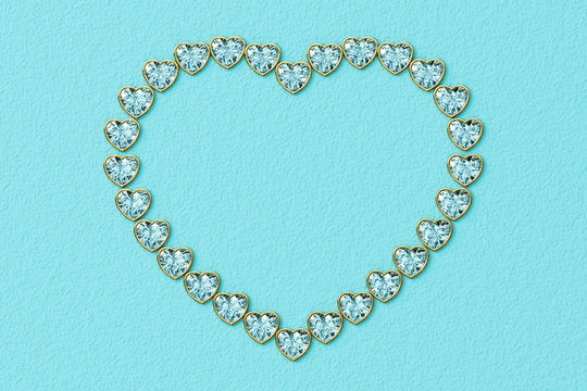 Heart-shaped frame made of small heart cut diamonds in yellow gold settings on turquoise textured background