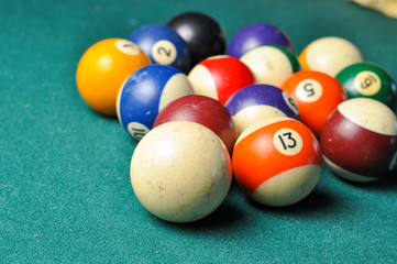 Old billiard balls composition on green pool table