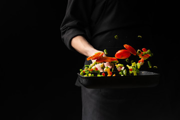 Professional chef. cooks vegetables in a pan, Asian cuisine. Oriental. background for the menu. recipe book
