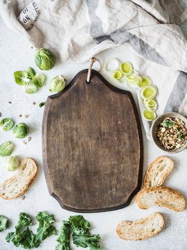Raw vegetarian ingredients for cooking, germinated seeds and bread slices on table and Blackboard in the middle for recipe recording