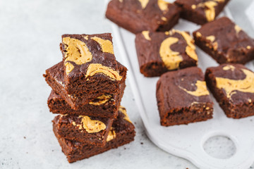 Vegan brownie with peanut butter on white background.