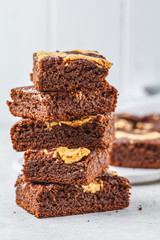 Vegan brownie with peanut butter on white background.
