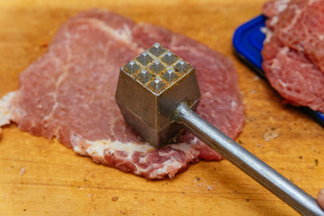 Raw meat sliced for cooking with meat hammer
