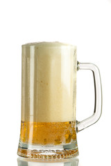 Pouring light beer in a beer mug, it turns out foam and spray