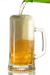Pouring light beer in a beer mug, it turns out foam and spray