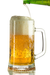 Pouring light beer in a beer mug, it turns out foam and spray