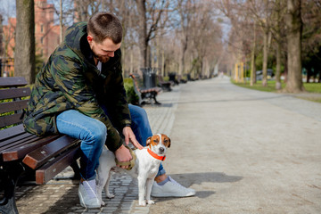 Young man with his dog, Jack Russell Terrier,