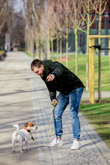 Young man with his dog, Jack Russell Terrier
