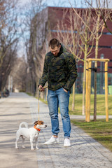 Young man with his dog, Jack Russell Terrier