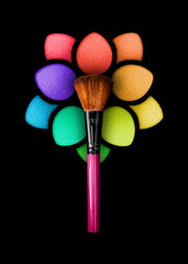 Professional make-up brush on a beautiful multicolored eyeshadow palette