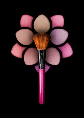 Professional make-up brush on a beautiful multicolored eyeshadow palette