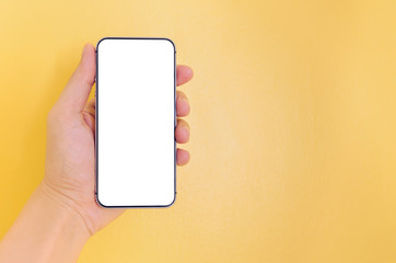 Human hand holding smartphone with white screen background.