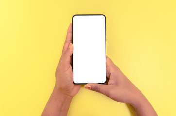 Human hand holding smartphone with white screen background.