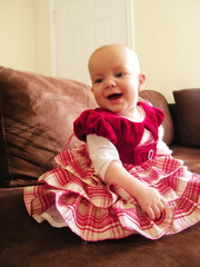 Infant girl in red Christmas dress