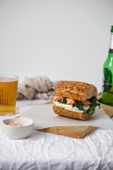 beer and sandwich with smoked salmon, red caviar, cream cheese, and kale cabbage