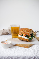 beer and sandwich with smoked salmon, red caviar, cream cheese, and kale cabbage