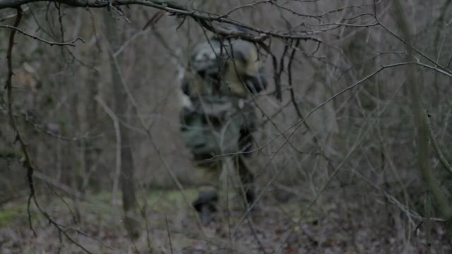 A group of scout saboteurs perform the task. An armed soldier without identification chevrons belonging to the army, terrorist, saboteur.