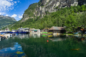 View of Geiranger village with sightseeing boats moored at the small port. Geiranger, Sunnmore, More og Romsdal, Norway, August 2018