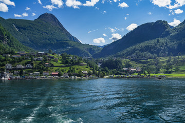 Geiranger village viewed from sightseeing boat on a cruise in the Geirangerfjord, Sunnmore, More og Romsdal, Norway