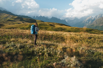 Naklejka premium female backpacker hiking in the mountains of Georgia