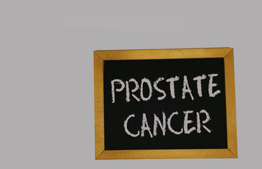 a sign lying on a gray background with the inscription prostate cancer