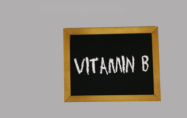 a sign lying on a gray background with the inscription vitamin B