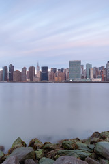 Fototapeta premium Midtown Manhattan view from East River beach at sunrise with long exposure