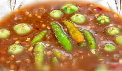 Thai dip of shrimp paste sauce topping with green and red chili. Hot and Spicy delicious traditional food. Close up