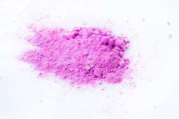 Pile of pink powder isolated on white background.