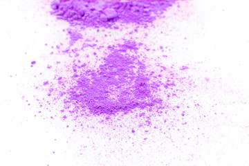 Pile of violet powder isolated on white background.