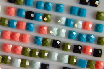 the background is multi-colored square elements of diamond mosaic.