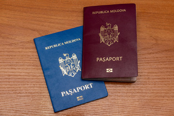 Biometric passports of citizens of the Republic of Moldova of red and blue colors. Covers of documents of different colors. Inscription - Republic of Moldova, Passport
