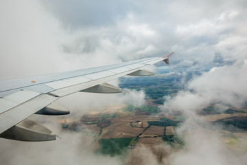 Fototapeta na wymiar Airplane flying above the english countryside