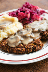 Lentil-mushroom burgers with mashed potatoes and red cabbage