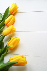 Tulips on white wooden table. View with copyspace