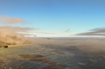 Low lying clouds over coastal wetlands at sunrise