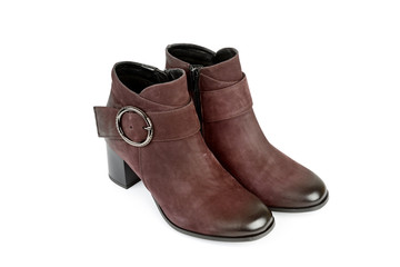 CloseUp of stylish suede ankle boots isolated on white background. City lifestyle. Female fashion.
