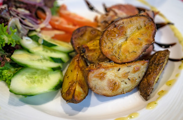 Roast potatoes with rosemary and salad