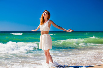 Young redhead girl at the beach.