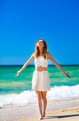 Young redhead girl at the beach.
